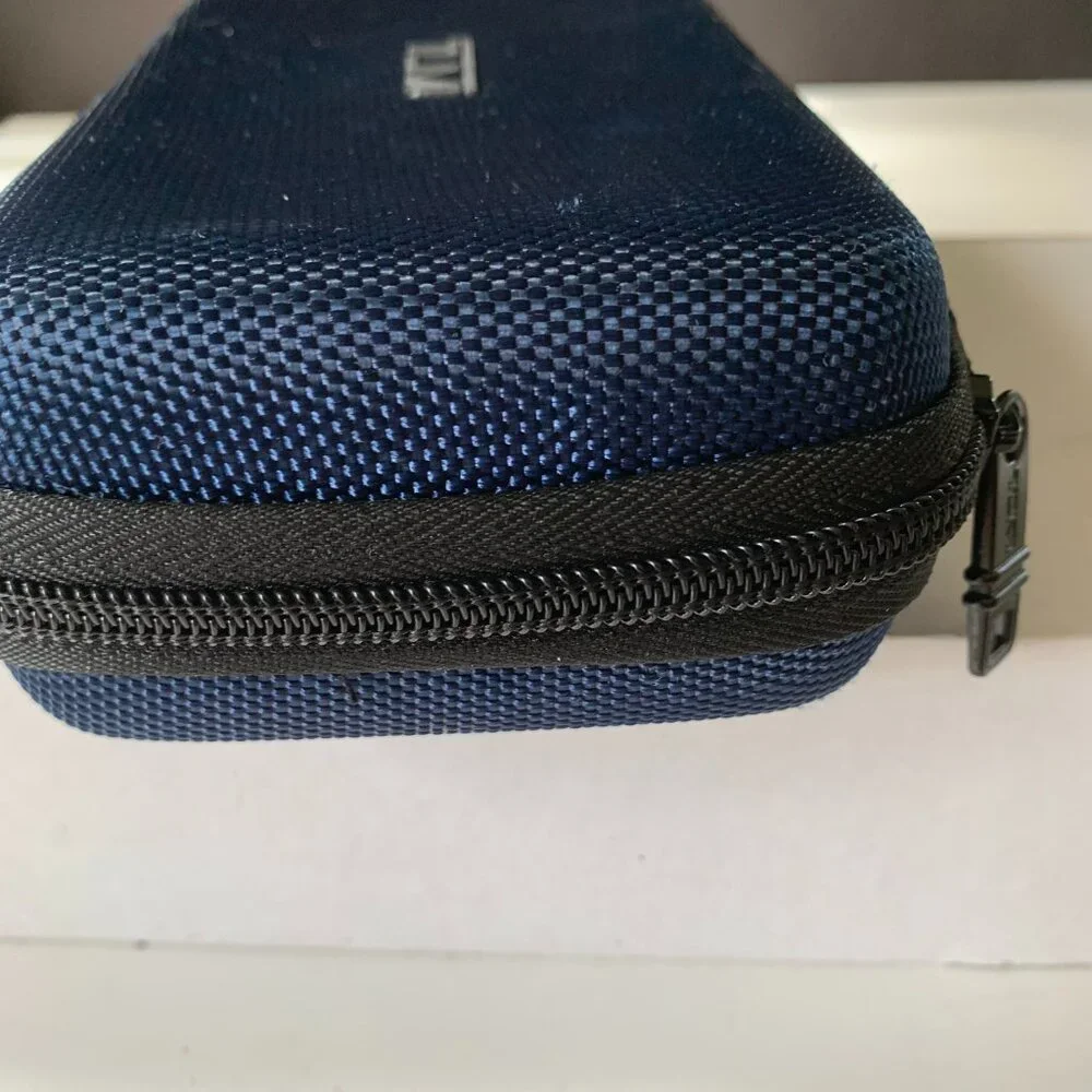 The product is a navy blue hard case amenity kit bag by TUMI for Delta Airlines.